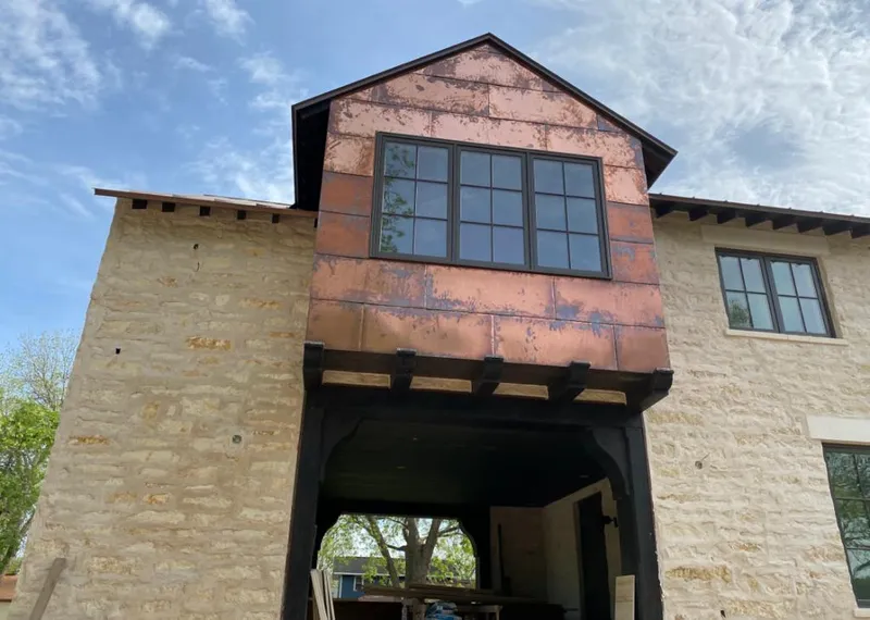 Copper metal panel facade on a stone building for Roof Repair in Rogersville